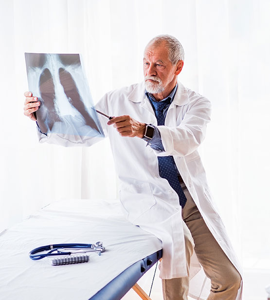 Doctor examining an x-ray of a patient's lungs.