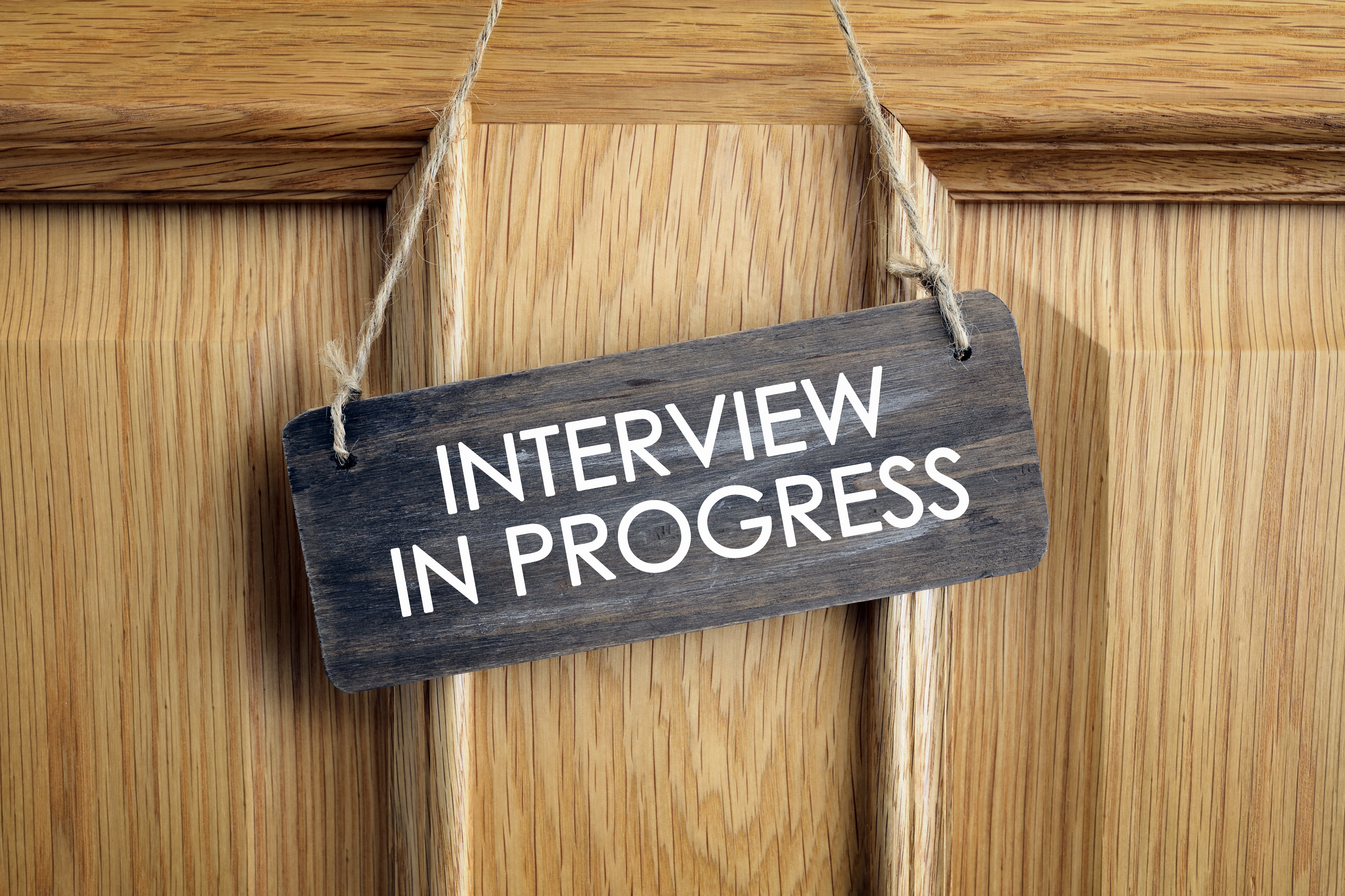 Interview in progress sign office door.