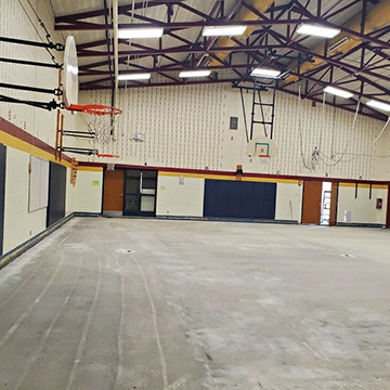Cleaning materials and tools in an indoor basketball court.