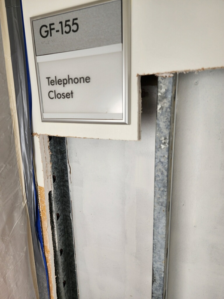Broken wall with a Telephone Closet Signage